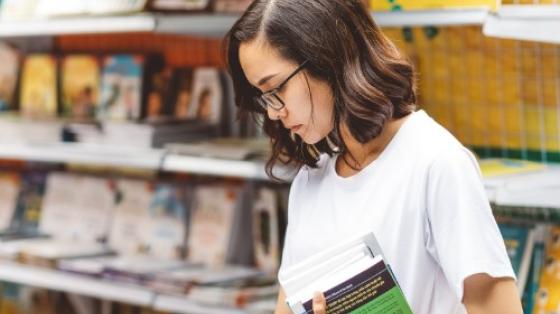 Woman looking at books