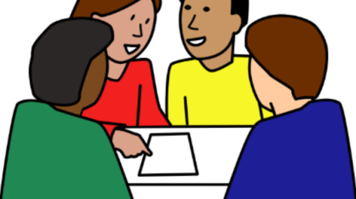 4 people talking around a table